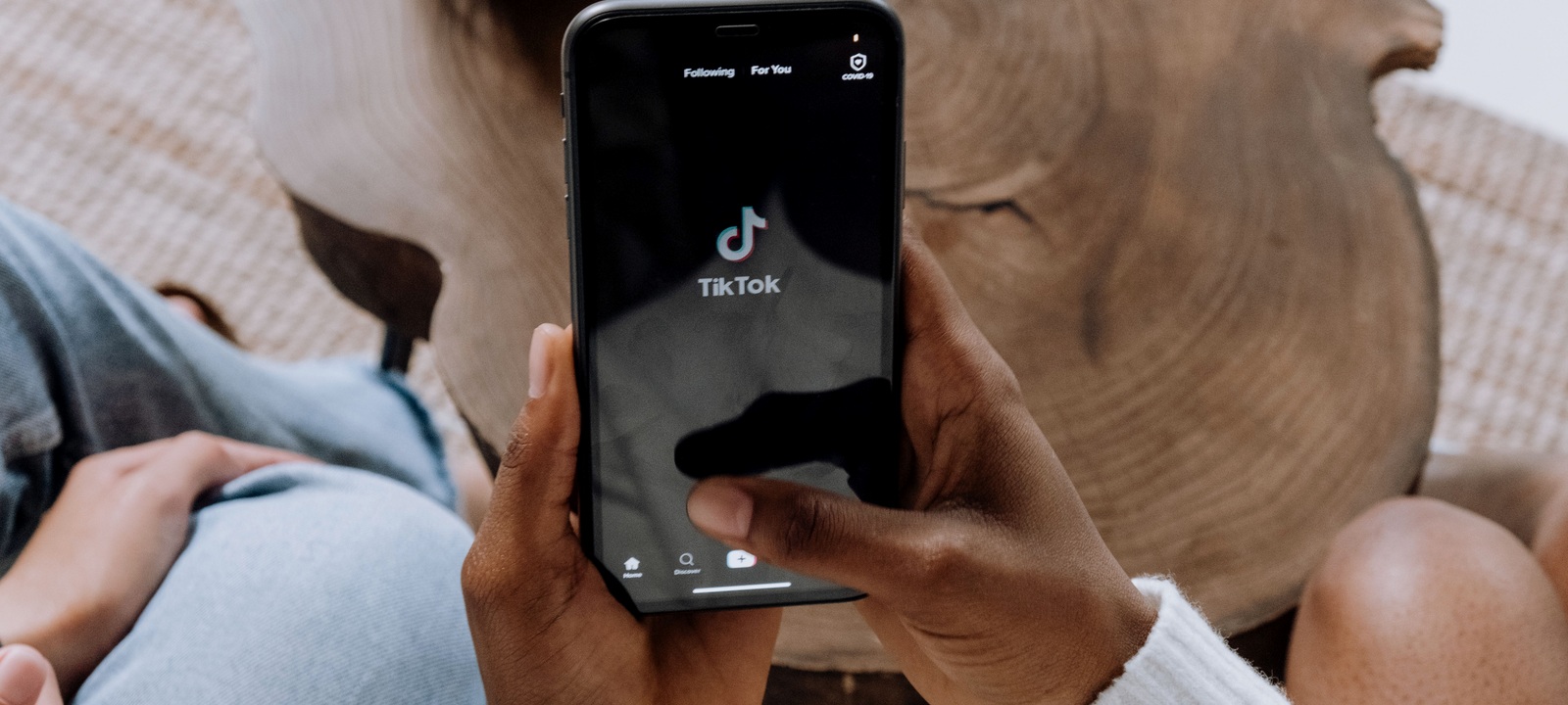 A person browsing TikTok on a smartphone